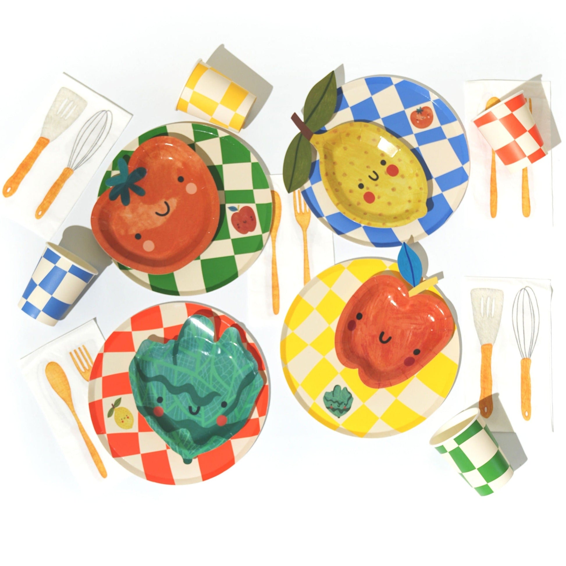 Colorful Essential Checkered Chef Party Pack set with plates, cups, napkins, and utensils for 12 persons featuring cheerful fruit and vegetable designs