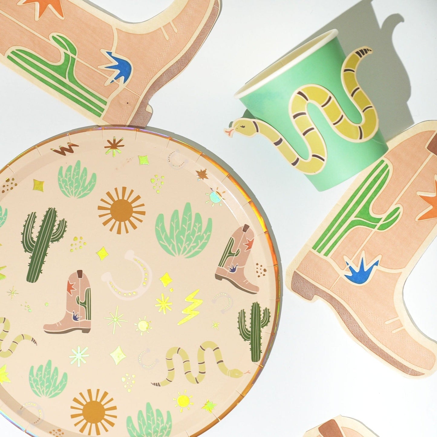 Western party pack with cactus-themed plates, snake-illustrated cups, and cowboy boot-shaped napkins for 12 people