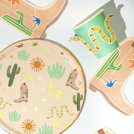 Western party pack with cactus-themed plates, snake-illustrated cups, and cowboy boot-shaped napkins for 12 people