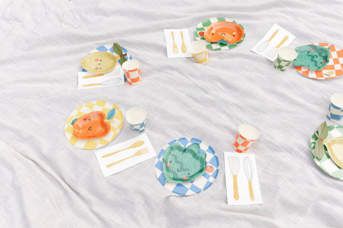 Essential Checkered Chef Party Pack with colorful plates, cups, and napkins for 12 kids' cooking-themed birthday party