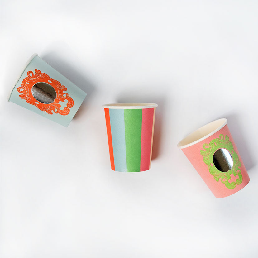 A set of paper cups with a shimmering mirror finish and striped patterns, designed for a princess-themed party.