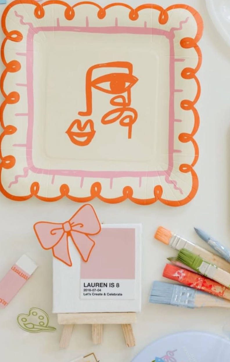 Art Party Dinner Plates set of 12 with Picasso-inspired orange and pink face design and artistic border