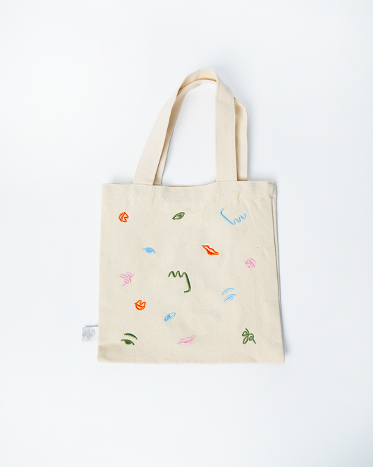 Mini tote bag with colorful abstract embroidery, kid-sized and reusable for art party theme events.