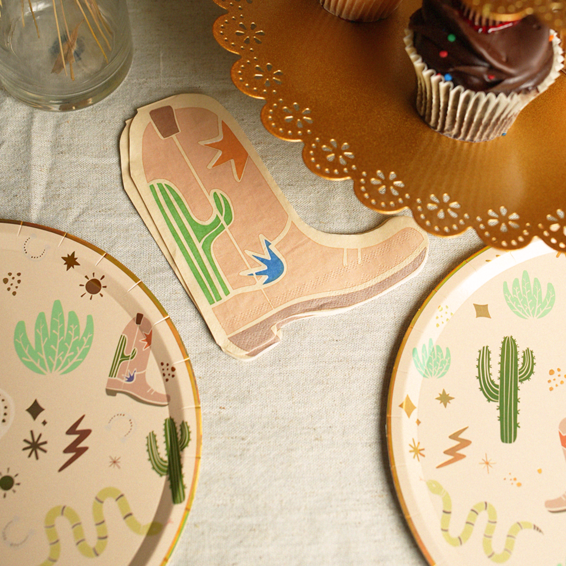 Western boot-shaped Sssssnake Catcher Napkins with cactus and star designs for a cowboy-themed party.