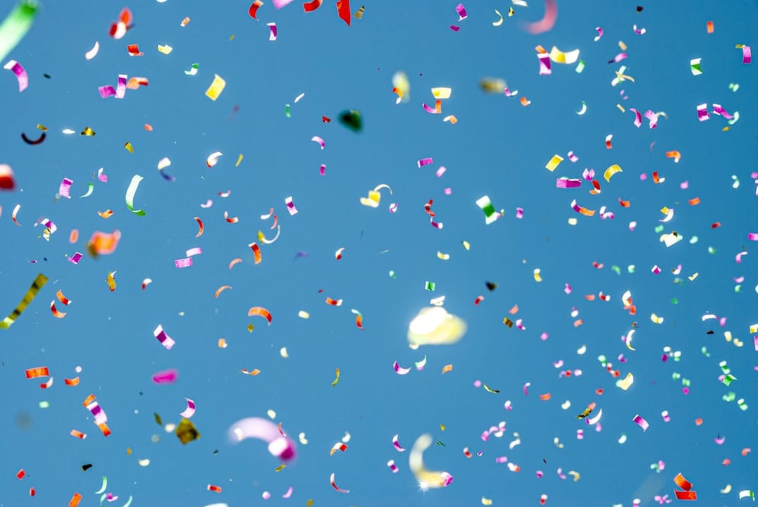 colorful confetti against blue sky