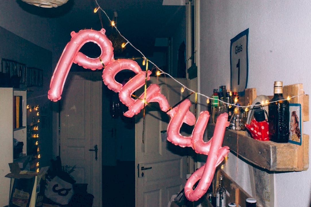 Woman planning party supplies at kitchen table