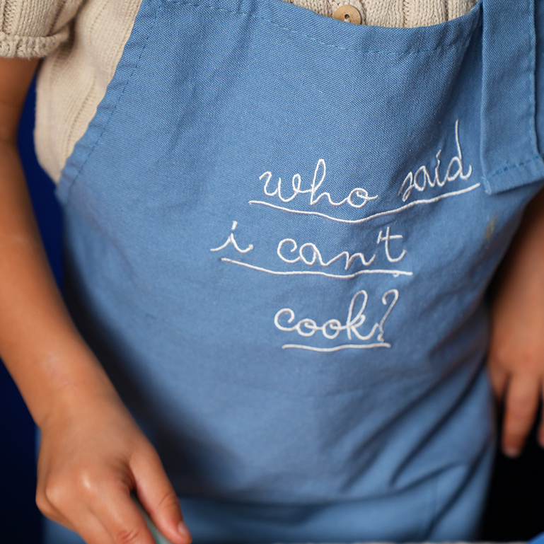 Little Chef Embroidered Linen ApronsGrab our Little Chef Embroidered Linen Aprons and look like a pro in the kitchen! With a white buckle, linen fabric, and a fun embroidered phrase on the front—"Who sPOP party suppliesChef Embroidered Linen cooking apron