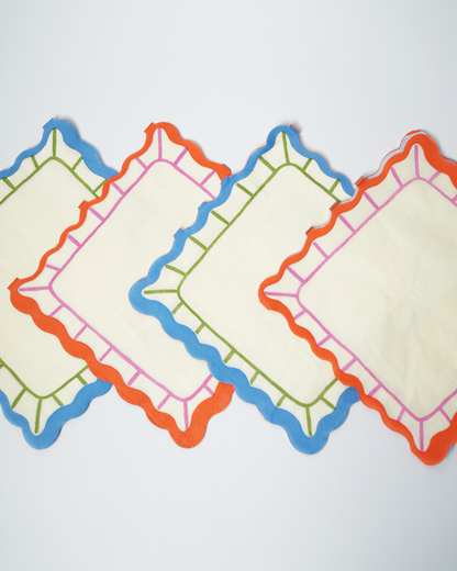Art Party Napkins with bright scalloped edges in blue, orange, and green colors